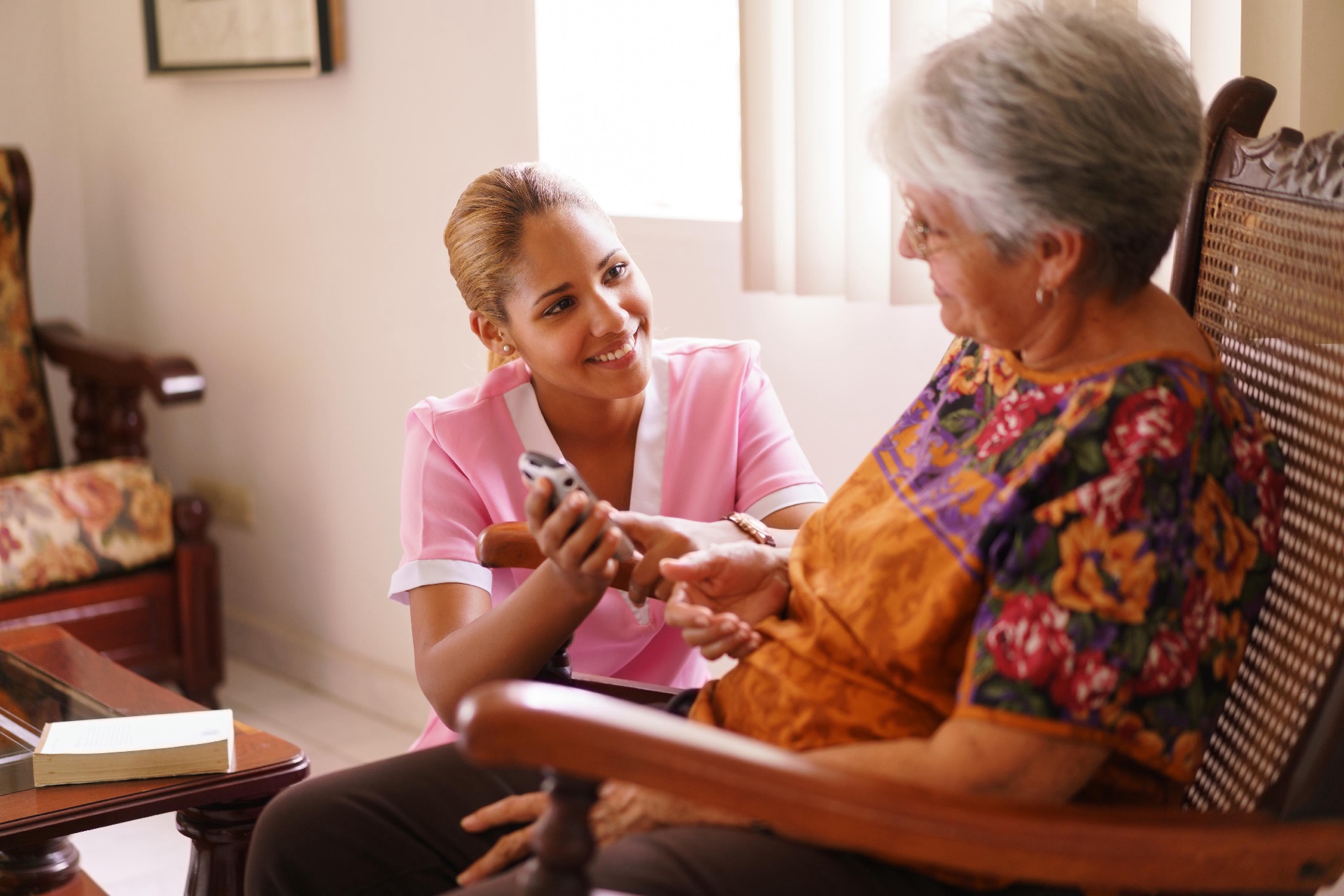 Caregiver and senior sharing tea